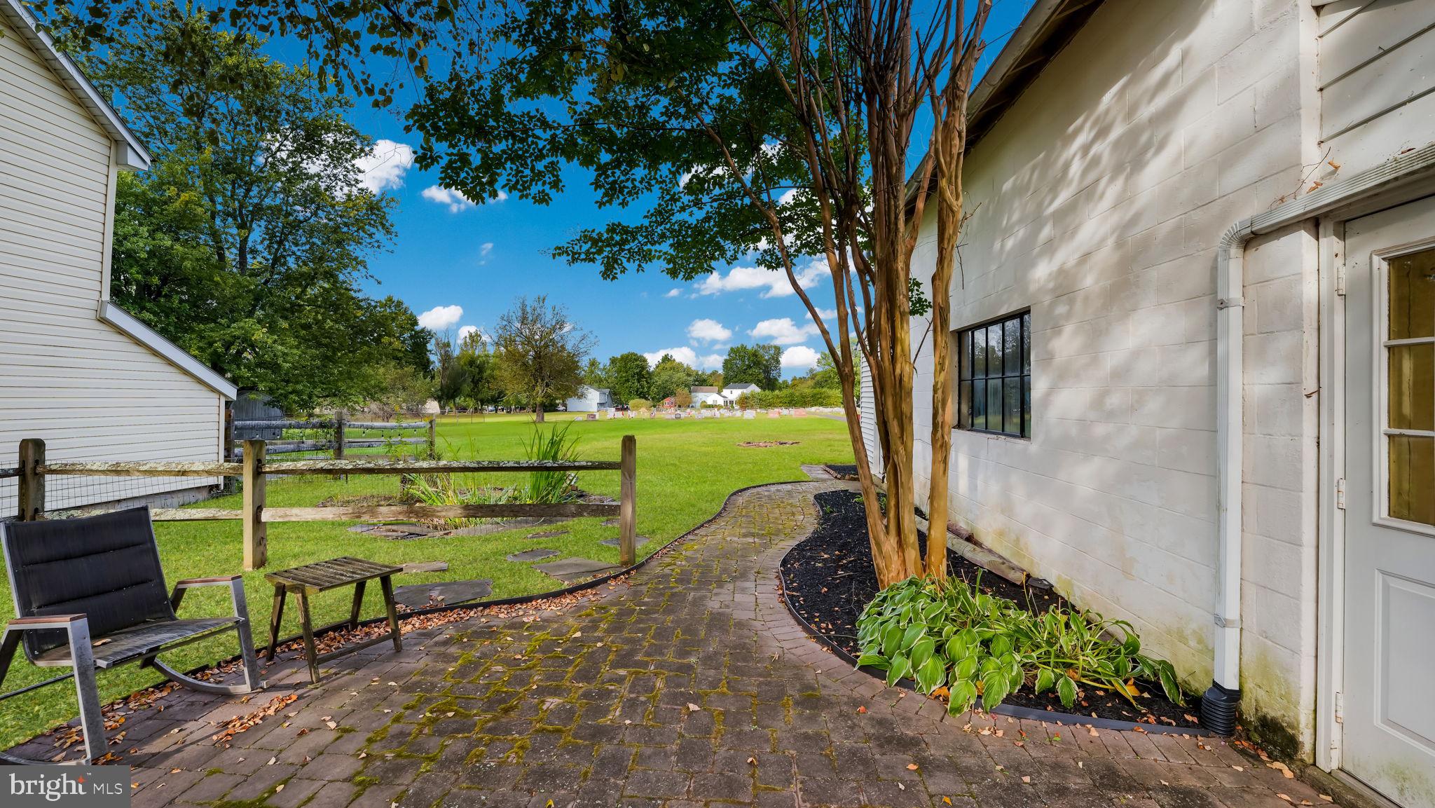 137 South Main Street Dublin, PA 18917 - Photo 26 of 29 a view of a backyard with table and chairs potted plants and large tree