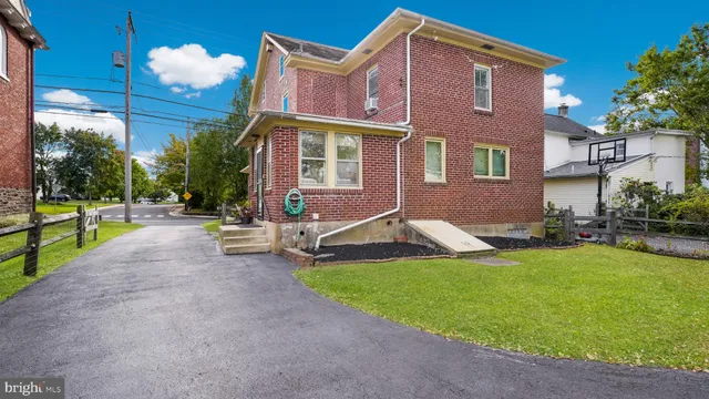 a front view of a house with swimming pool yard and patio
