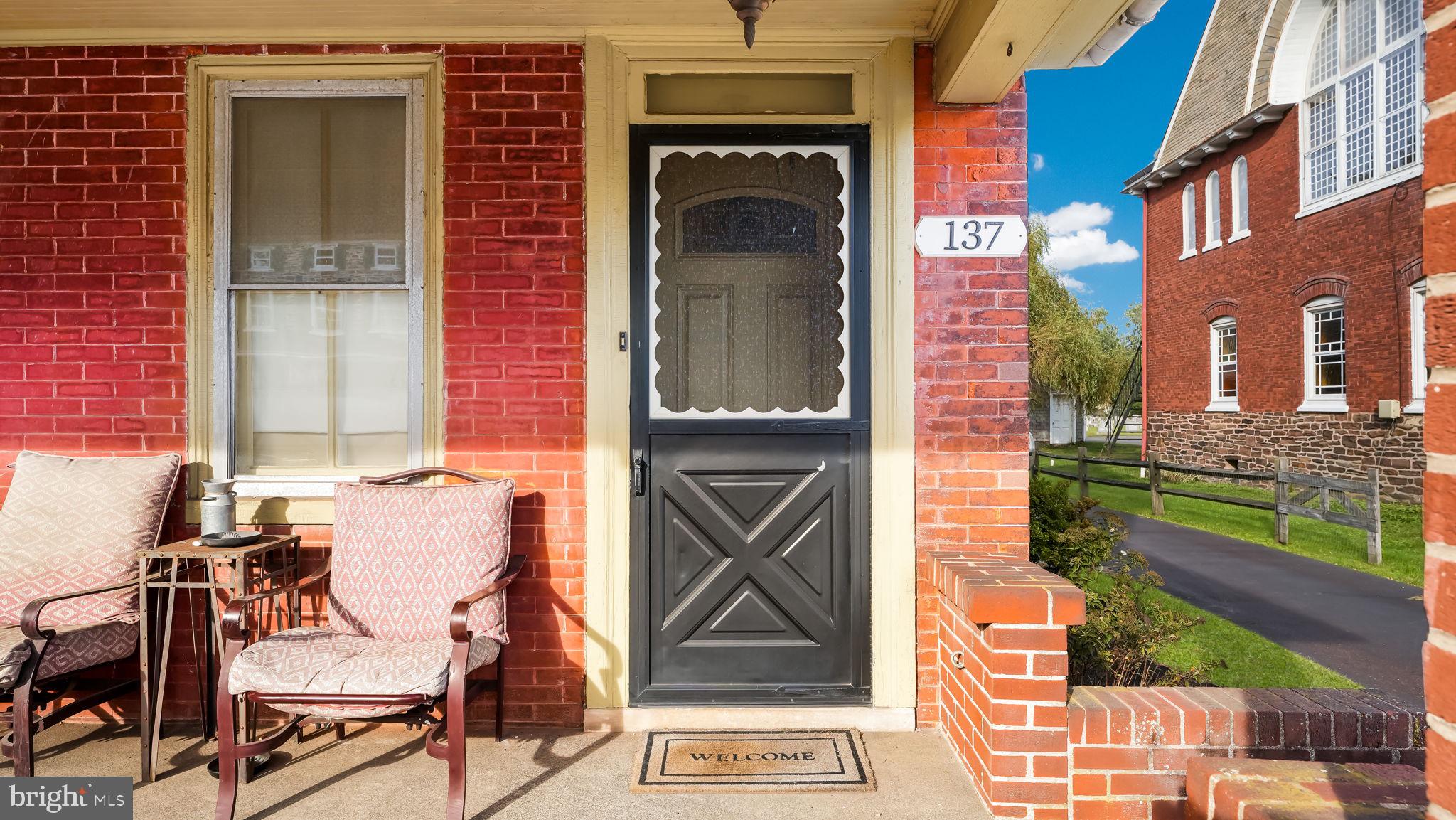 137 South Main Street Dublin, PA 18917 - Photo 4 of 29 a front view of a house with many windows