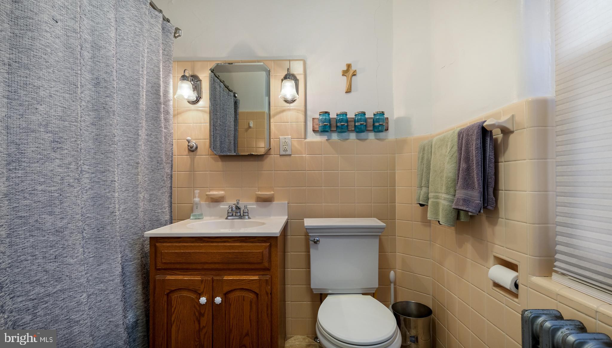 137 South Main Street Dublin, PA 18917 - Photo 9 of 29 a bathroom with a sink vanity mirror and toilet