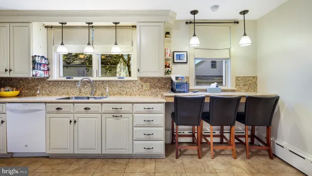 a kitchen with stainless steel appliances granite countertop a sink and cabinets