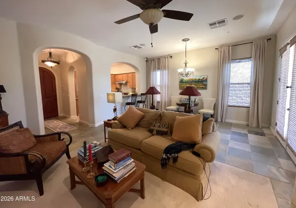 a living room with furniture a window and a flat screen tv