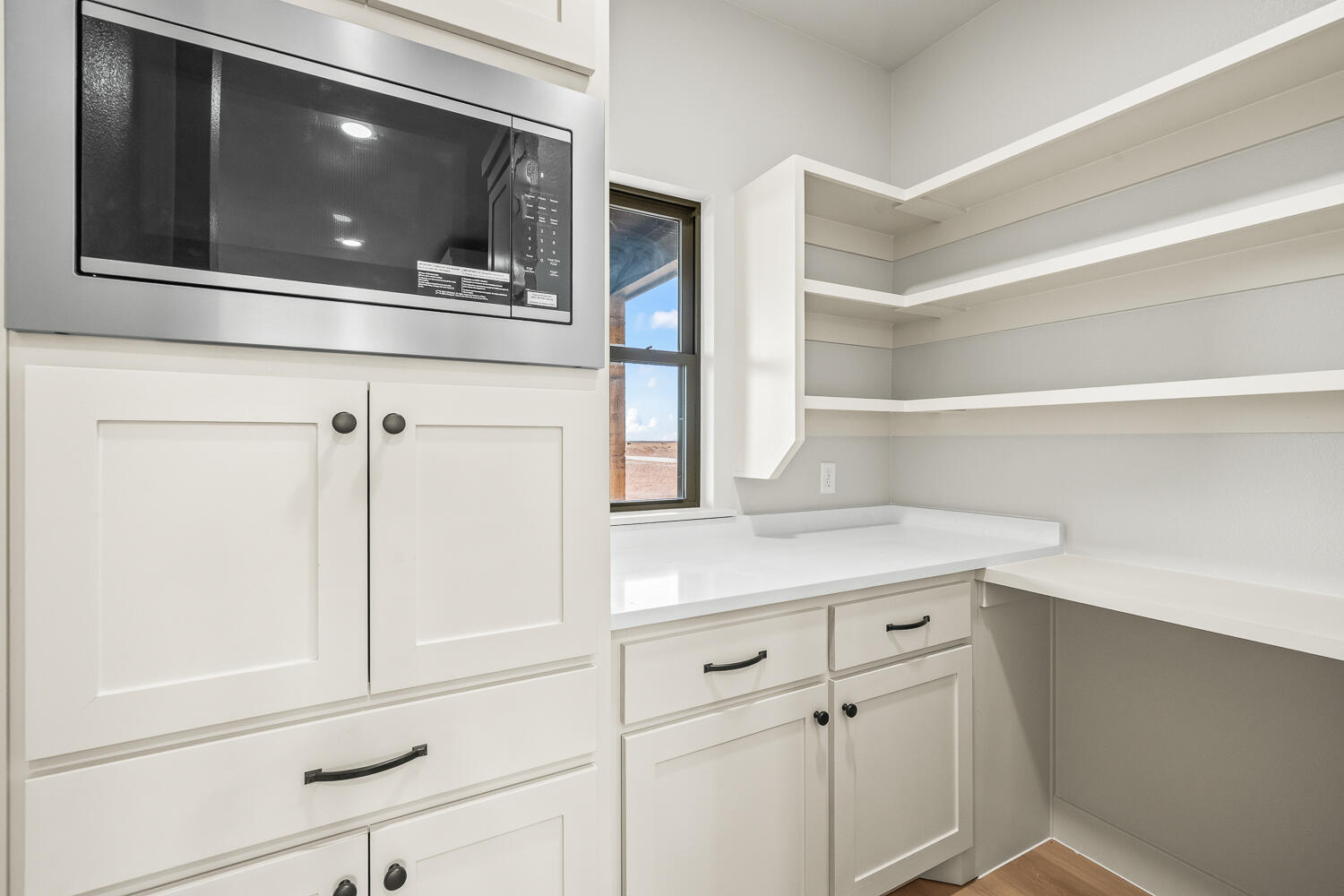 5603 County Road 6100 Lubbock, TX 79415 - Photo 15 of 46 a kitchen with a microwave and cabinets