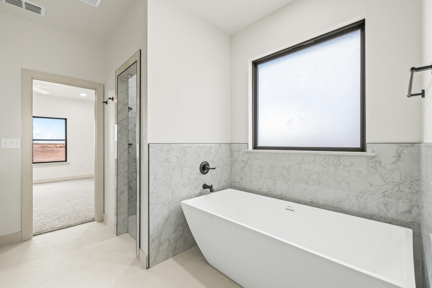 5603 County Road 6100 Lubbock, TX 79415 - Photo 26 of 46 a bathroom with a bathtub and a shower