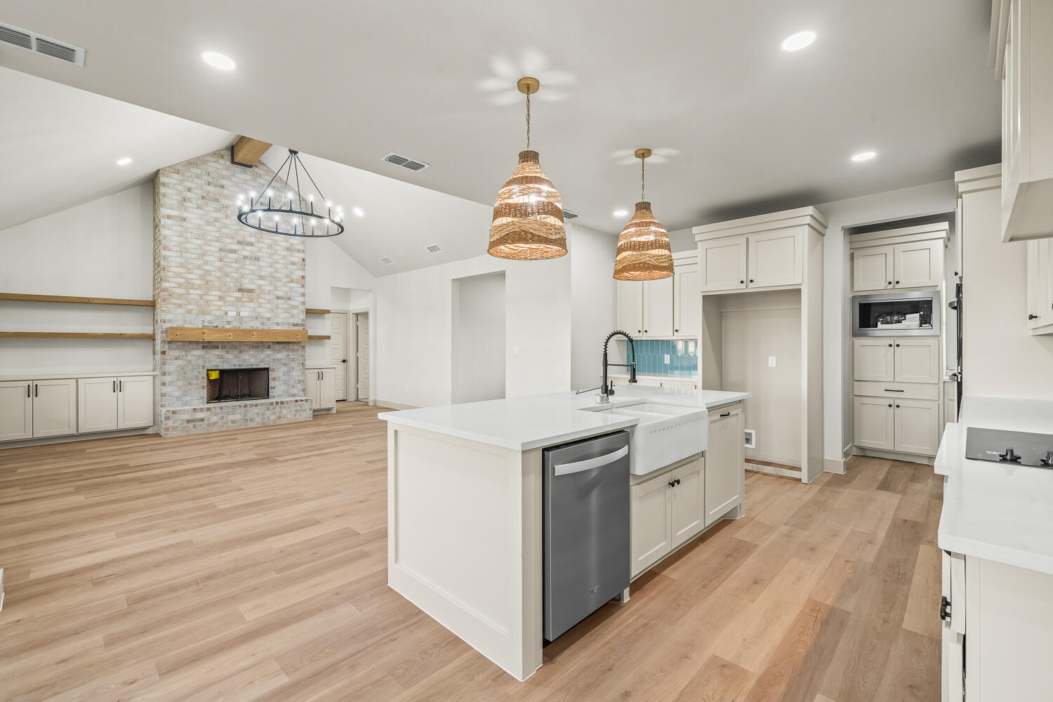 5603 County Road 6100 Lubbock, TX 79415 - Photo 32 of 46 a kitchen with kitchen island granite countertop a stove oven and a wooden floors