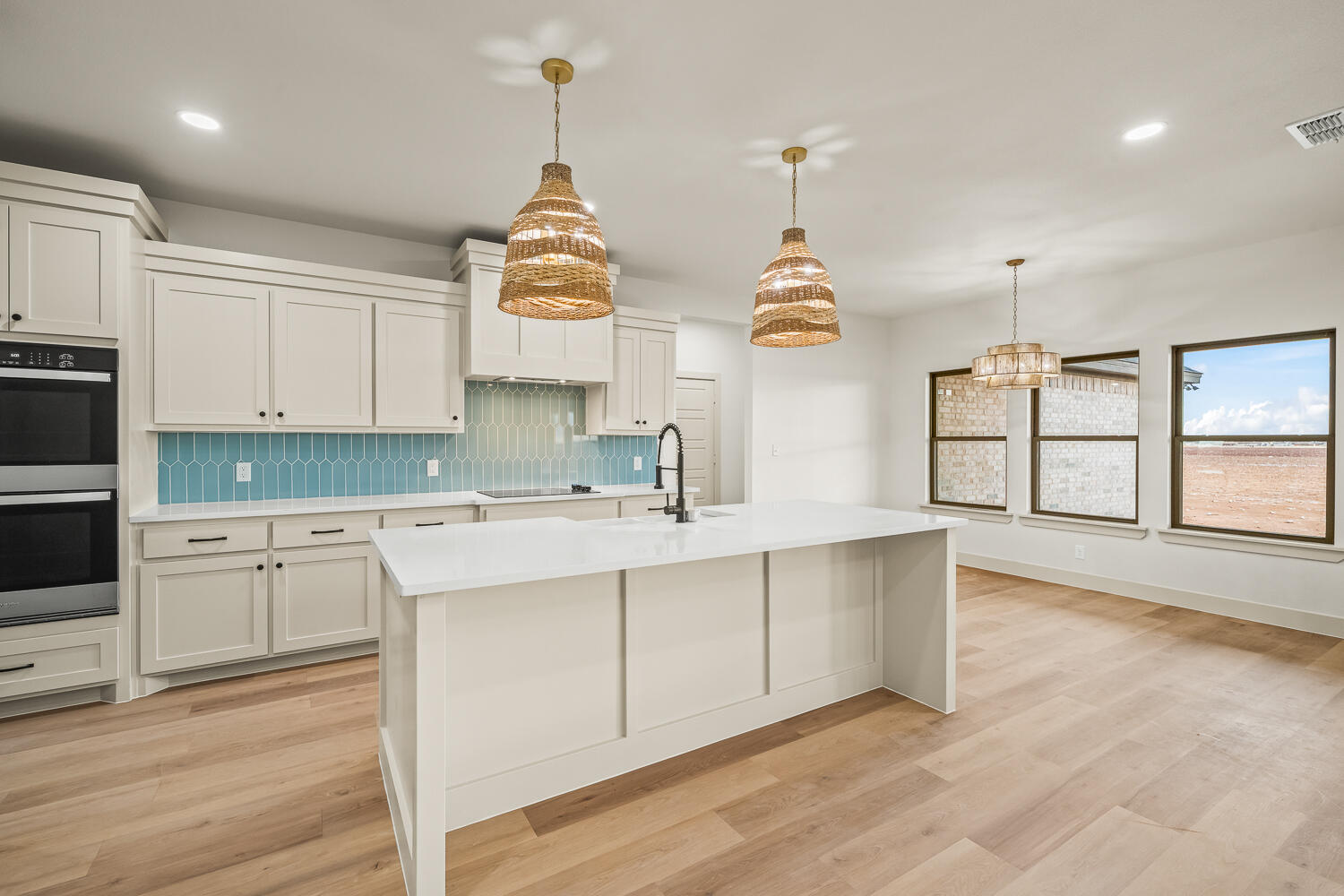 5603 County Road 6100 Lubbock, TX 79415 - Photo 35 of 46 a kitchen with stainless steel appliances granite countertop a sink a stove and a wooden floors