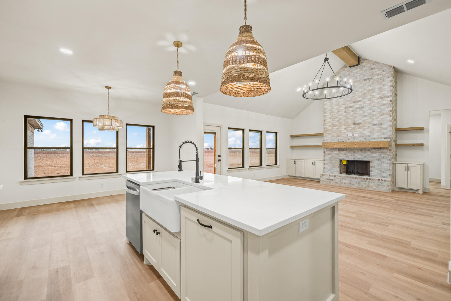 5603 County Road 6100 Lubbock, TX 79415 - Photo 36 of 46 an open kitchen with a sink and dishwasher with wooden floor