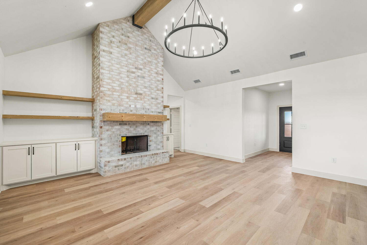5603 County Road 6100 Lubbock, TX 79415 - Photo 41 of 46 a view of an empty room with a fireplace and chandelier fan