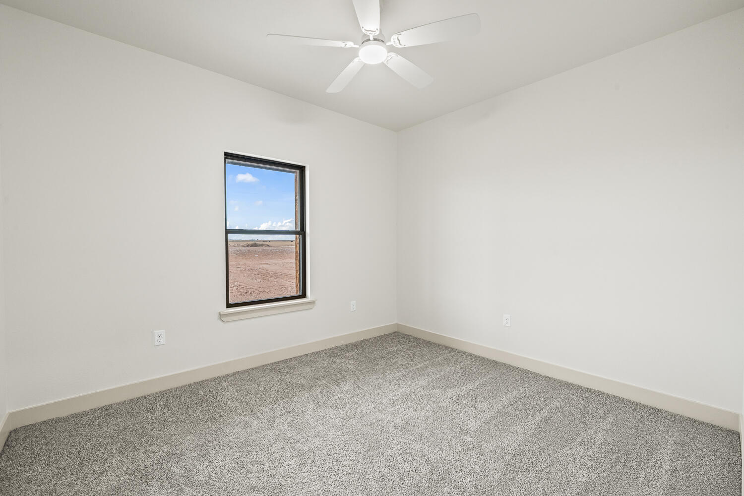 5603 County Road 6100 Lubbock, TX 79415 - Photo 5 of 46 an empty room with a window and a fan
