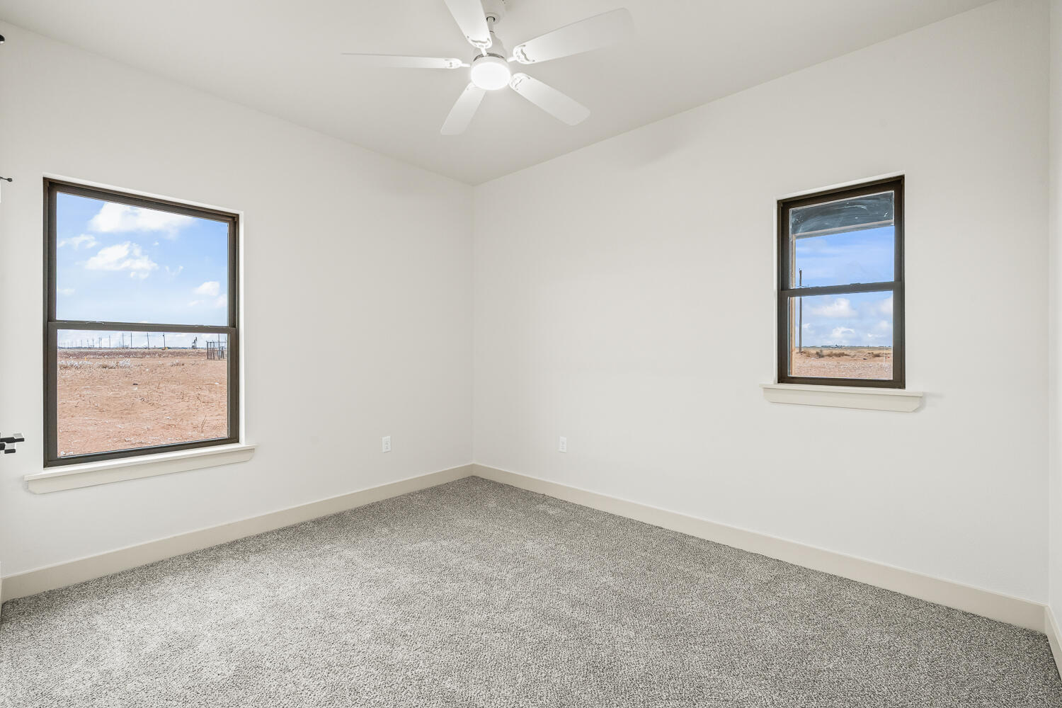 5603 County Road 6100 Lubbock, TX 79415 - Photo 7 of 46 an empty room with a window and a fan