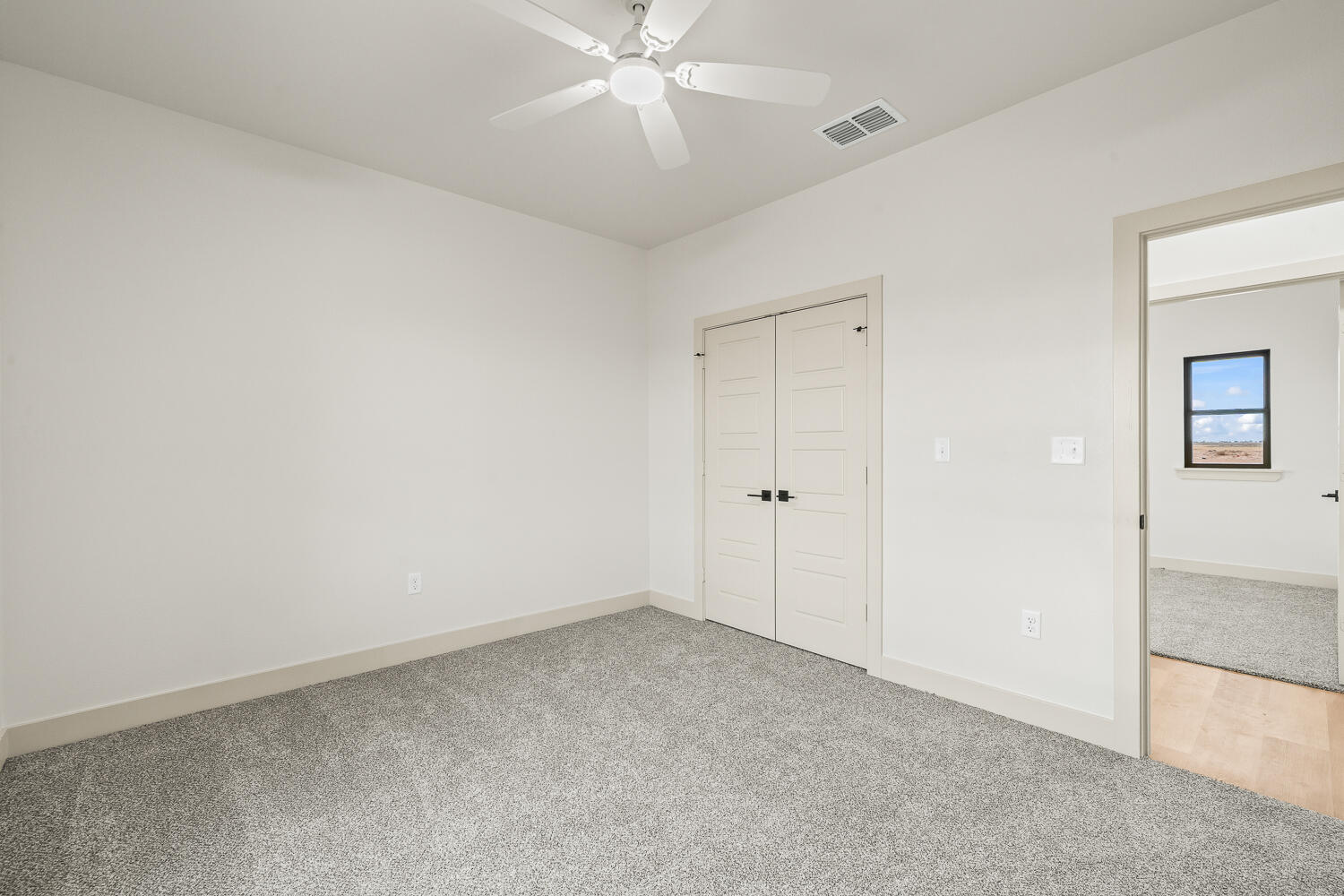 5603 County Road 6100 Lubbock, TX 79415 - Photo 10 of 46 an empty room with a ceiling fan and a window