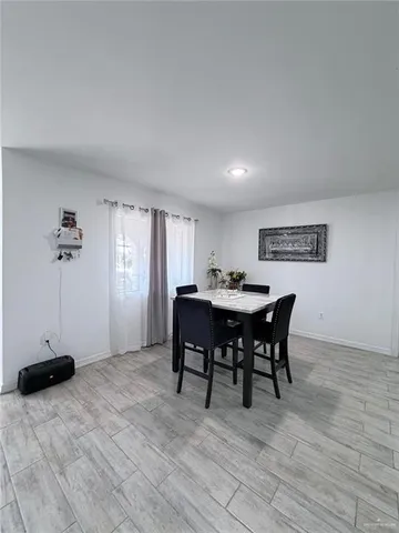 a view of a dining room with furniture and a window