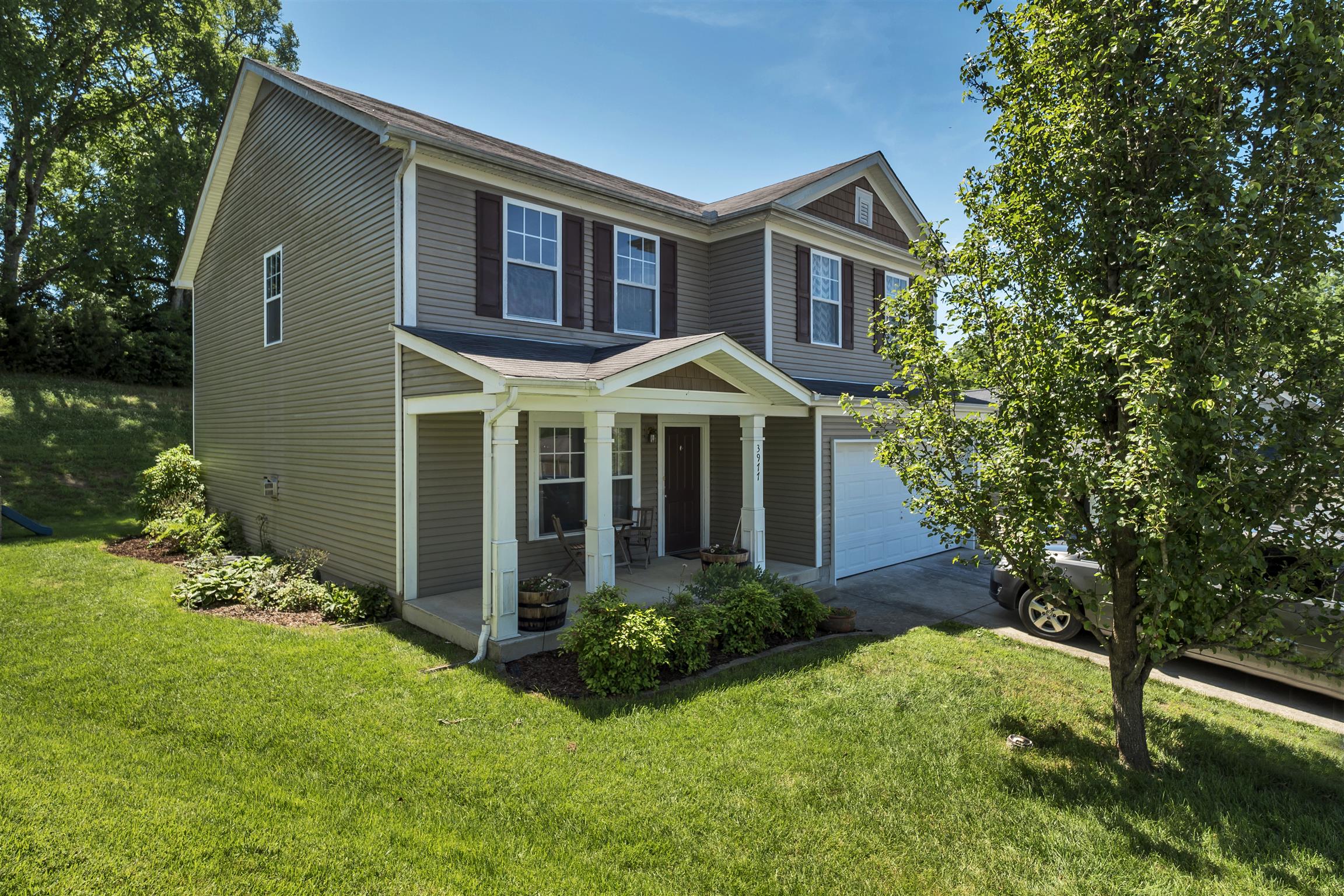 3977 Stephens Ridge Way Antioch, TN 37013 - Photo 1 of 23 a front view of a house with a yard and trees