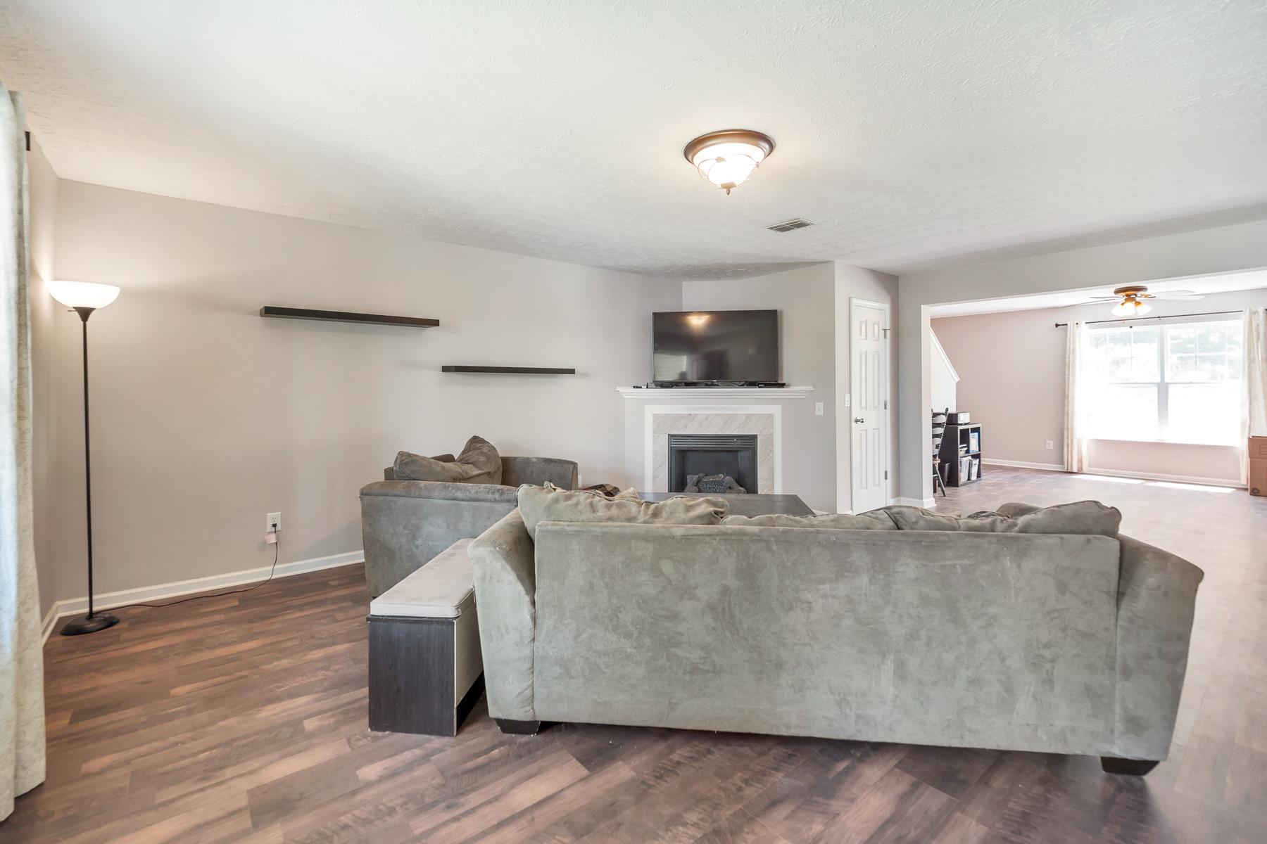 3977 Stephens Ridge Way Antioch, TN 37013 - Photo 5 of 23 a living room with furniture a fireplace and a flat screen tv