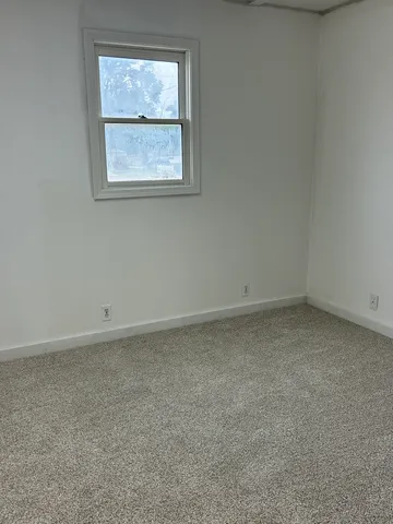 a view of an empty room with a window