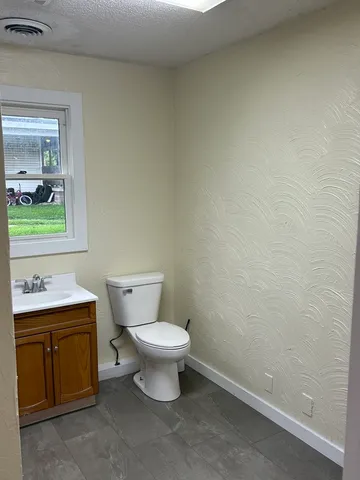 a view of an empty room with a closet