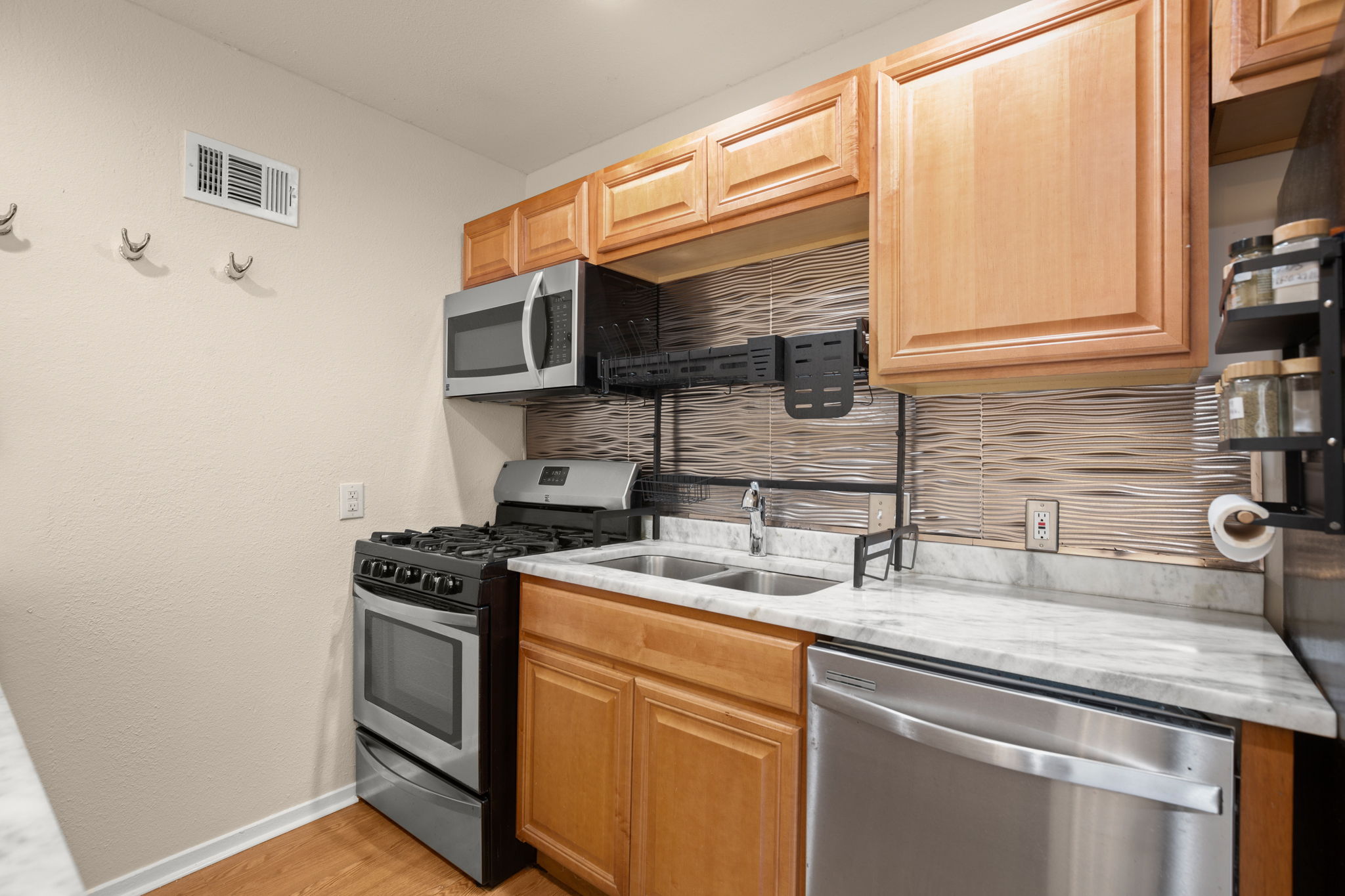 1912 Lightsey Road, Unit 2 Austin, TX 78704 - Photo 19 of 25 a kitchen with stainless steel appliances granite countertop a sink a stove and a microwave