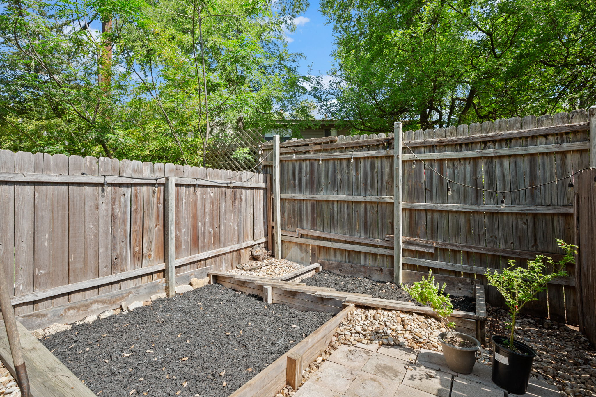 1912 Lightsey Road, Unit 2 Austin, TX 78704 - Photo 21 of 25 a view of a backyard with a wooden fence