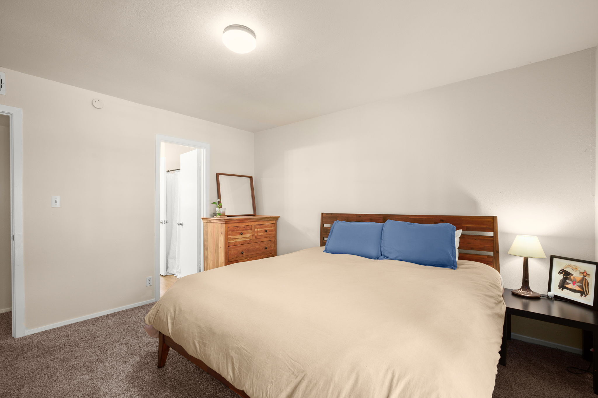 1912 Lightsey Road, Unit 2 Austin, TX 78704 - Photo 7 of 25 a large bed sitting in a bedroom next to a lamp