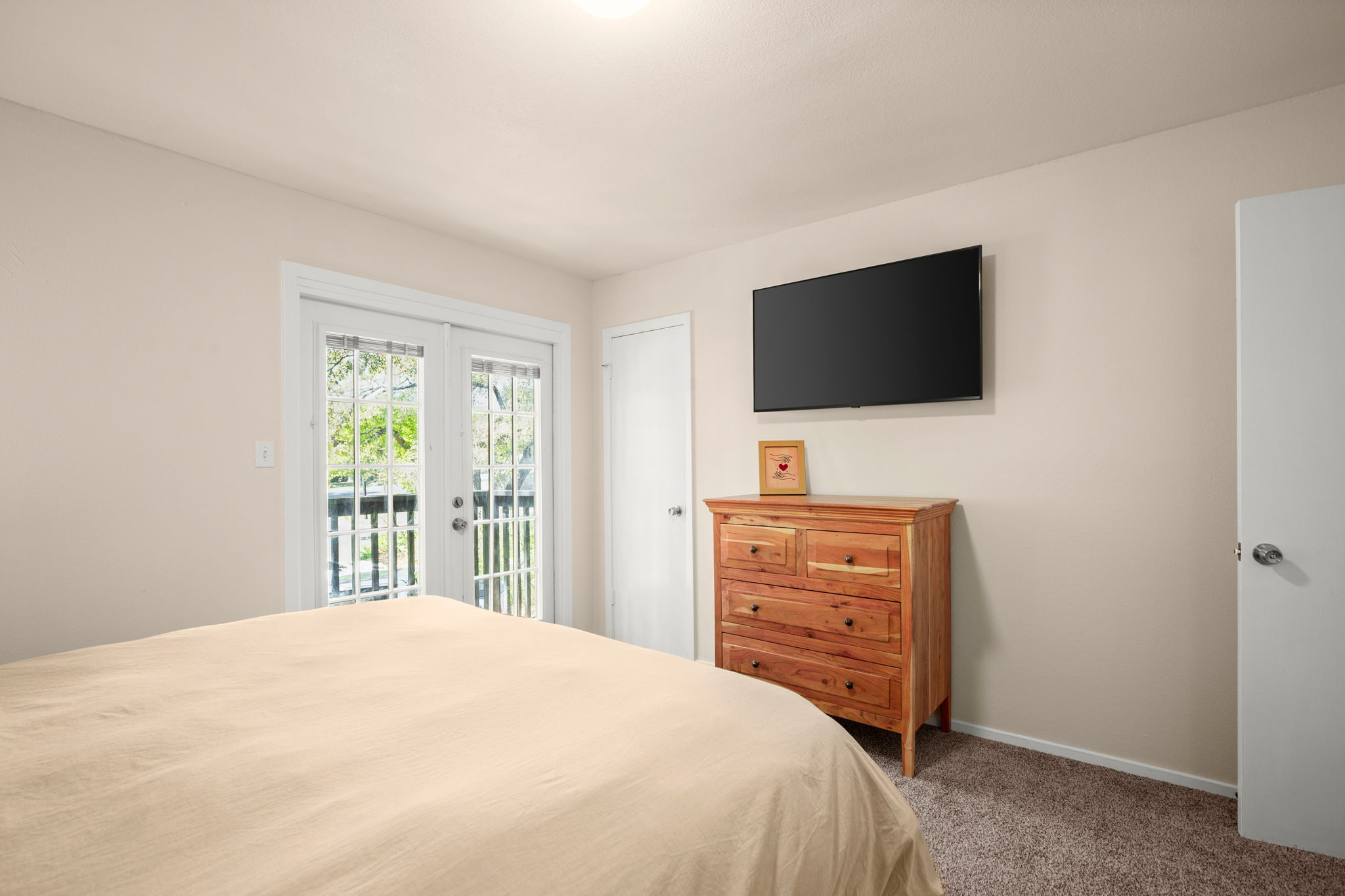 1912 Lightsey Road, Unit 2 Austin, TX 78704 - Photo 8 of 25 a bedroom with a bed and a flat screen tv