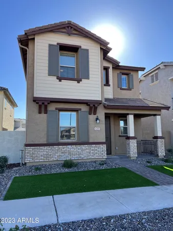 a brick house with a small yard in front of it