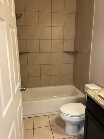 a bathroom with a bathtub and a toilet