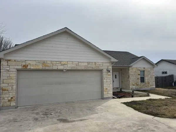 a front view of a house with garage