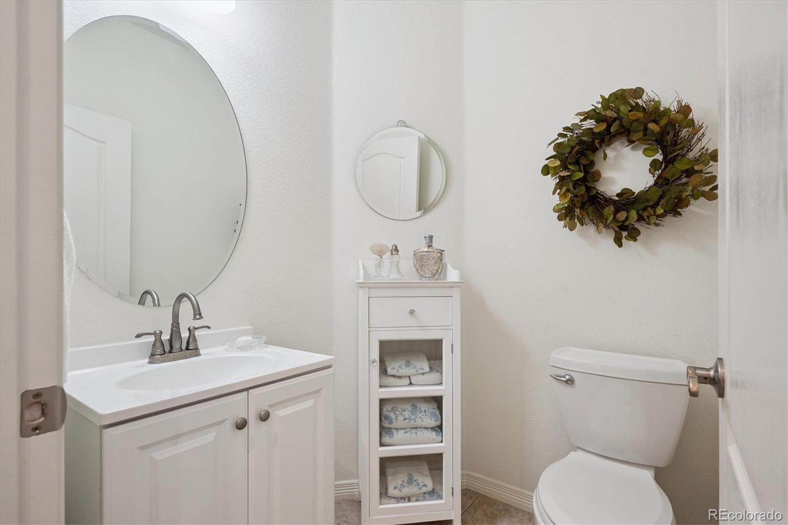 9851 Greensview Circle Lone Tree, CO 80124 - Photo 12 of 27 a bathroom with a toilet sink and mirror