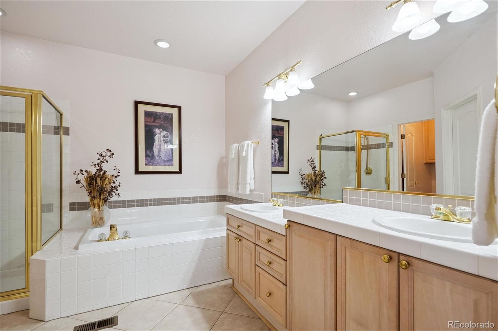 9851 Greensview Circle Lone Tree, CO 80124 - Photo 15 of 27 a spacious bathroom with a tub a sink and mirror