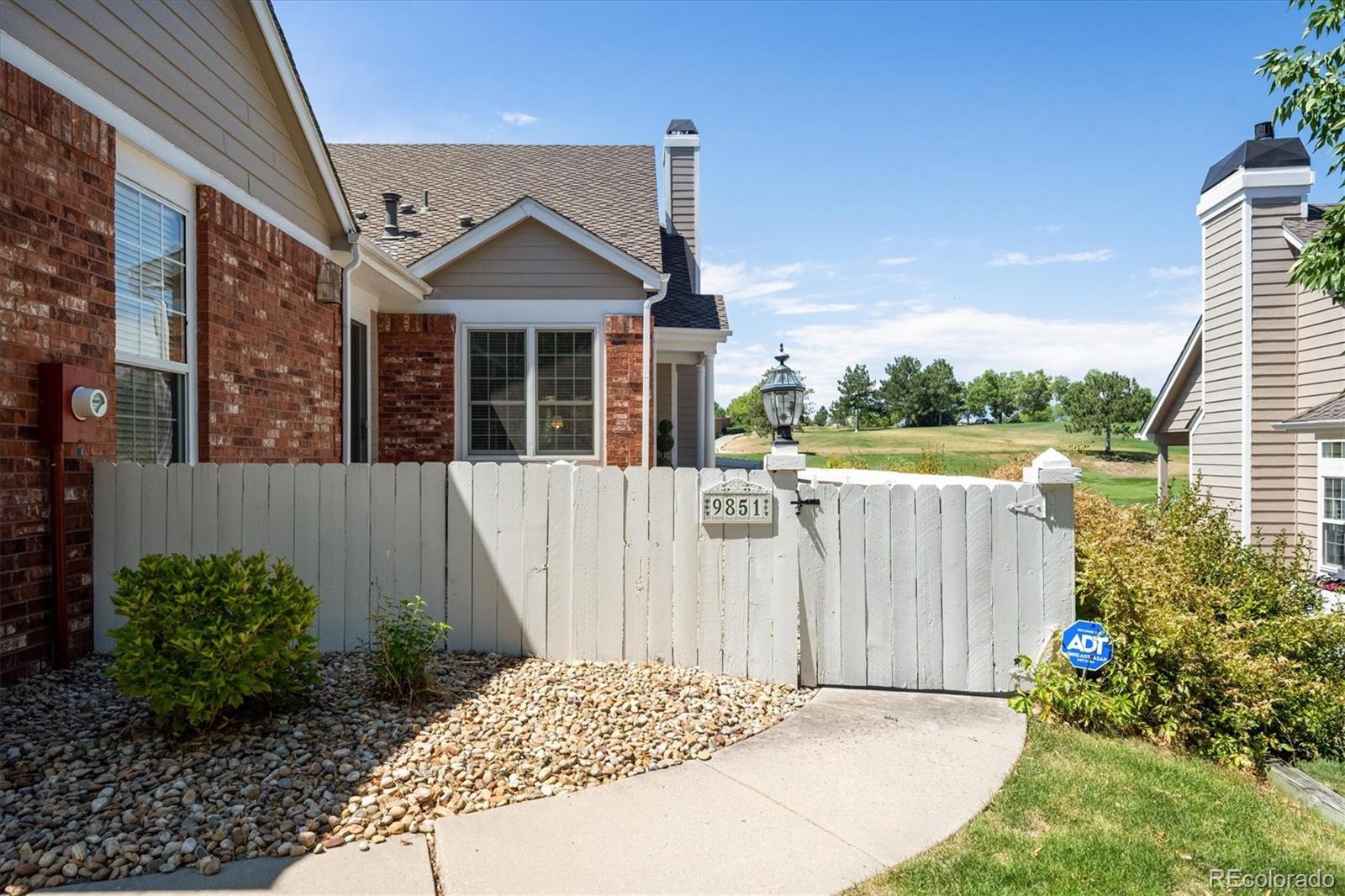 9851 Greensview Circle Lone Tree, CO 80124 - Photo 4 of 27 a view of a house with a small yard and plants