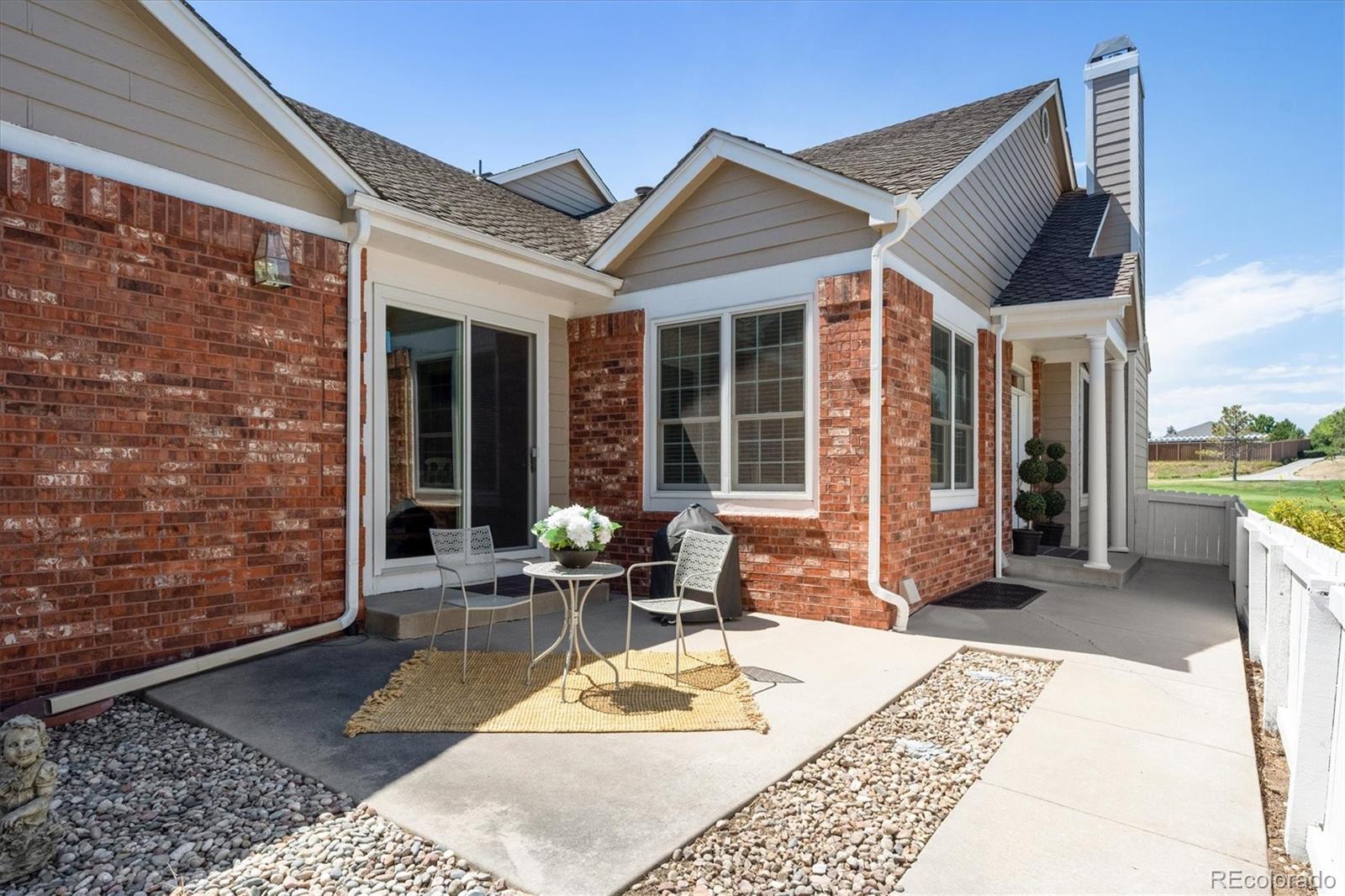 9851 Greensview Circle Lone Tree, CO 80124 - Photo 5 of 27 a view of a patio with table and chairs with wooden floor and fence