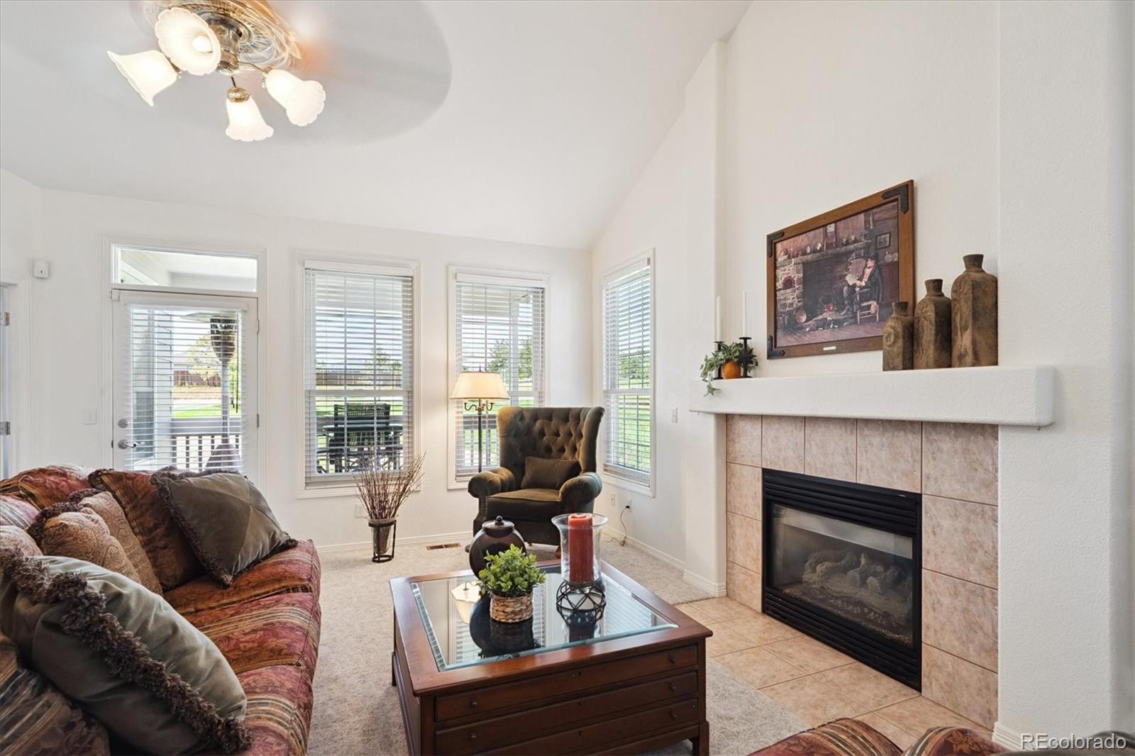 9851 Greensview Circle Lone Tree, CO 80124 - Photo 8 of 27 a living room with furniture a fireplace and a large mirror