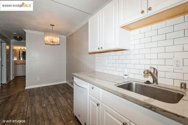 a kitchen with a sink cabinets and wooden floor