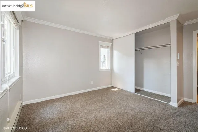 a view of an empty room with a closet
