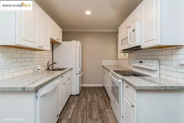a kitchen with a sink stove and cabinets