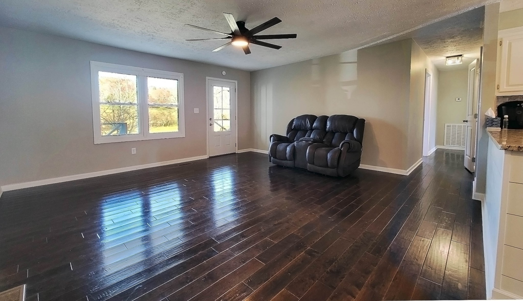 3149 Old Well Road Morrison, TN 37357 - Photo 7 of 43 a view of a livingroom with wooden floor and a ceiling fan