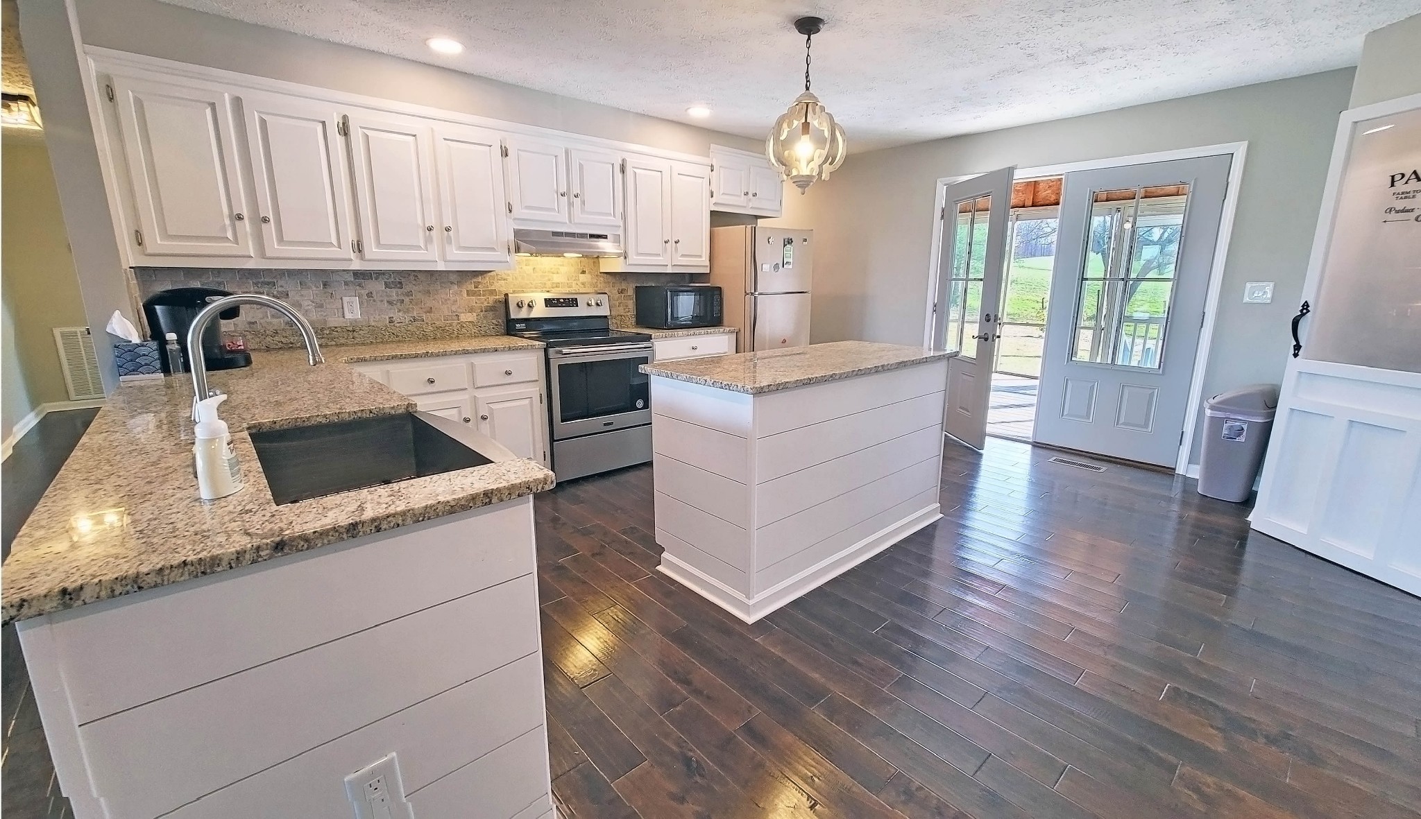 3149 Old Well Road Morrison, TN 37357 - Photo 9 of 43 a kitchen with granite countertop white cabinets and white appliances
