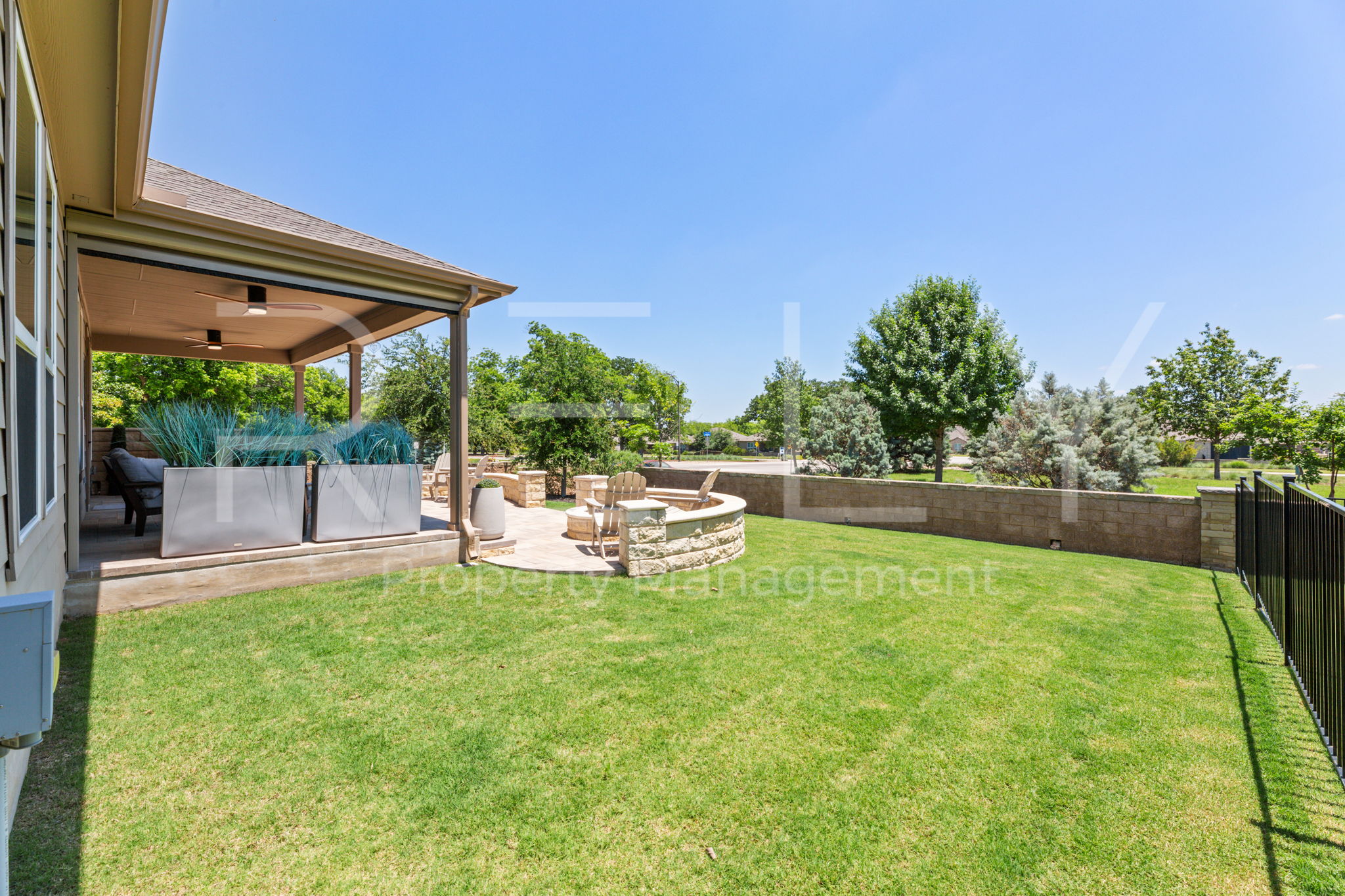 101 Spanish Star Street Georgetown, TX 78633 - Photo 39 of 39 Enjoy outdoor living with a spacious covered patio, verdant lawn, and a cozy fire pit area.