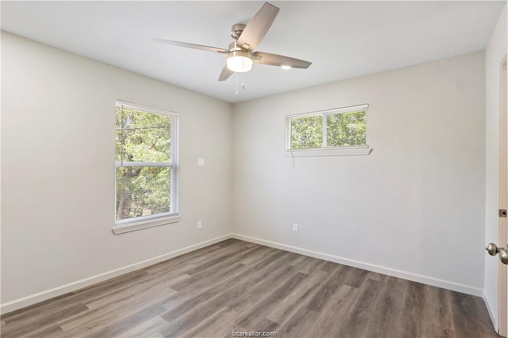 1504 Alpine Circle, Unit D College Station, TX 77840 - Photo 13 of 17 an empty room with a window and a ceiling fan