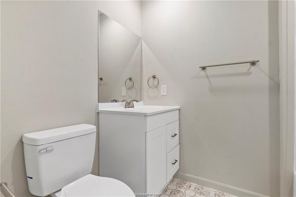 1504 Alpine Circle, Unit D College Station, TX 77840 - Photo 15 of 17 a bathroom with a toilet sink and mirror