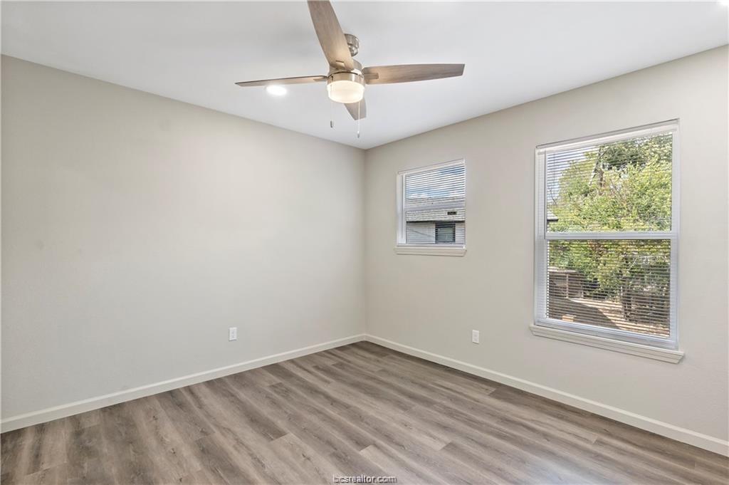 1504 Alpine Circle, Unit D College Station, TX 77840 - Photo 16 of 17 an empty room with a window and a ceiling fan