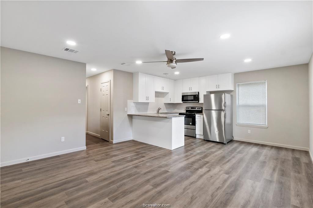 1504 Alpine Circle, Unit D College Station, TX 77840 - Photo 5 of 17 a view of kitchen with stainless steel appliances refrigerator stove microwave and cabinets