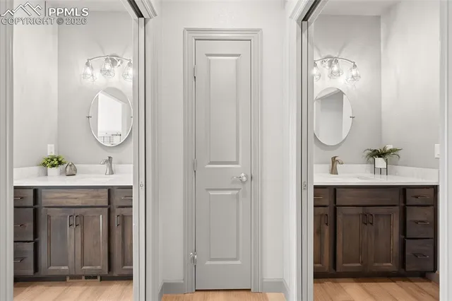 a bathroom with a sink vanity and mirror