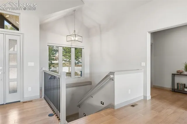 a living room with furniture a flat screen tv and a large window