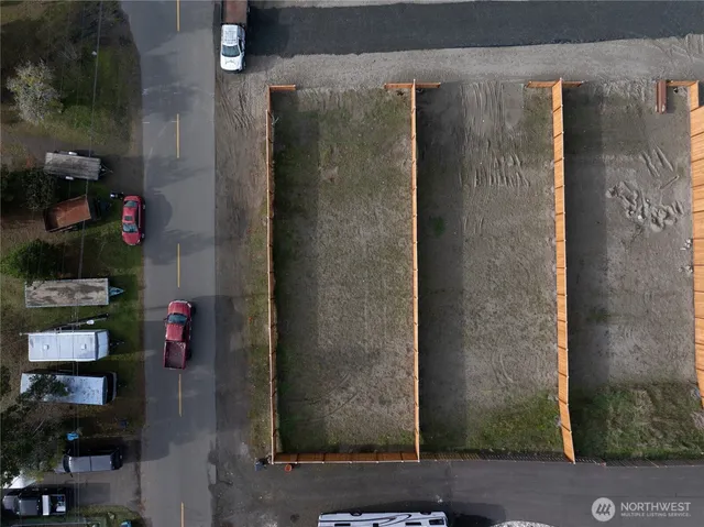 an aerial view of a house with a yard basket ball court and outdoor seating