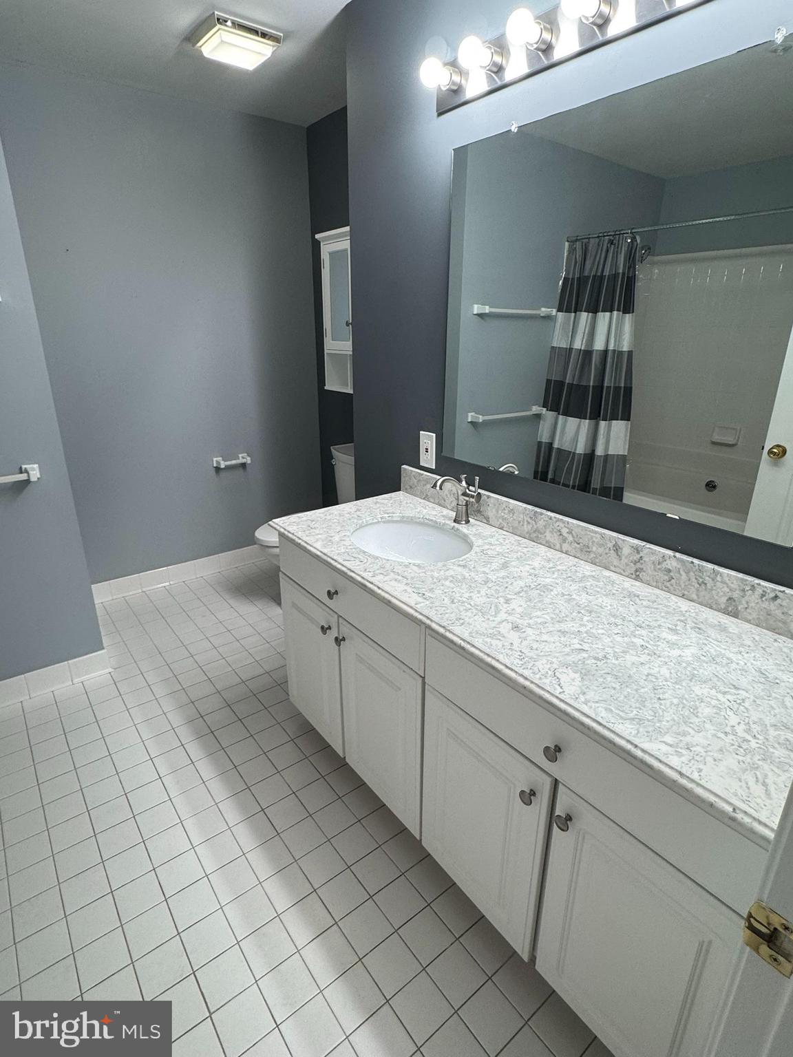 102 Mercer Court, Unit 21 3 Frederick, MD 21701 - Photo 17 of 31 a spacious bathroom with a granite countertop sink and a mirror