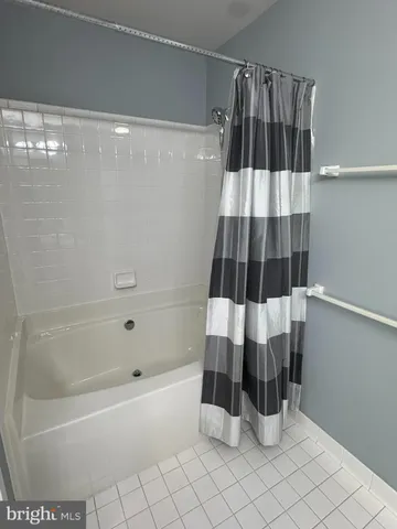 a bathroom with a bathtub and shower