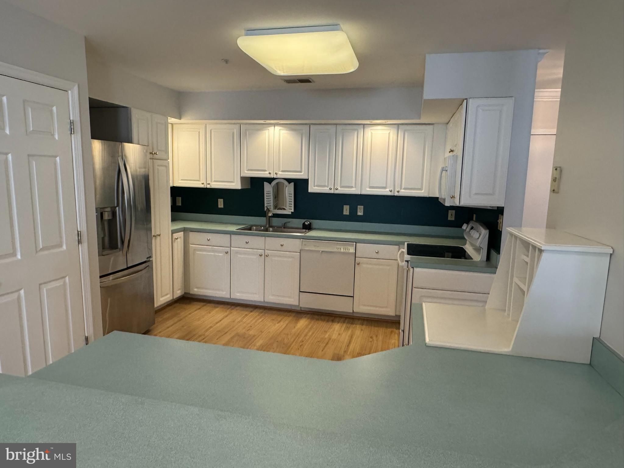 102 Mercer Court, Unit 21 3 Frederick, MD 21701 - Photo 5 of 31 a kitchen with a sink cabinets and stainless steel appliances