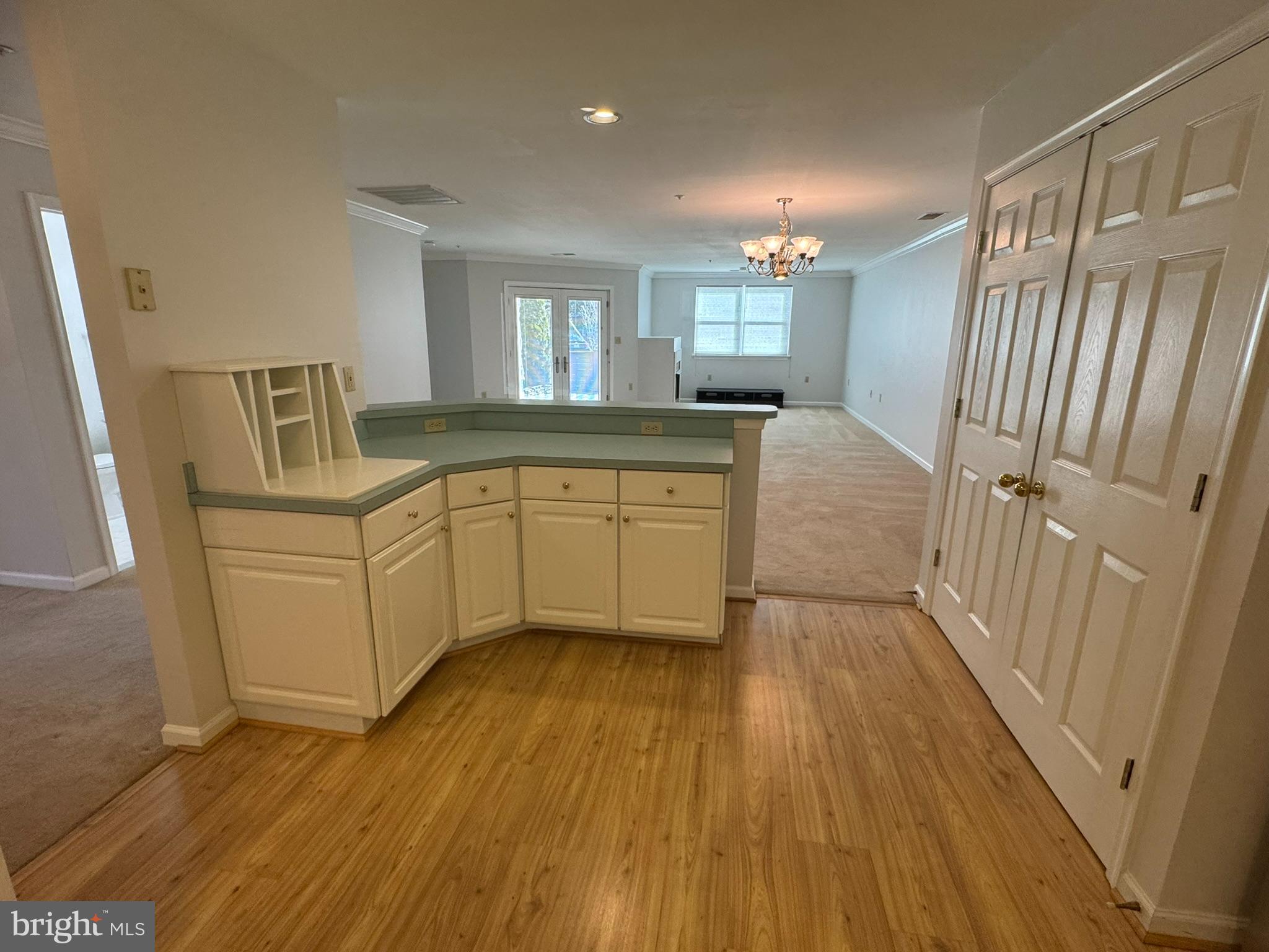 102 Mercer Court, Unit 21 3 Frederick, MD 21701 - Photo 6 of 31 a view of a kitchen with wooden floor and staircase