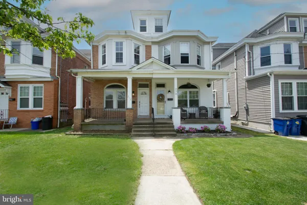 a front view of house with a garden
